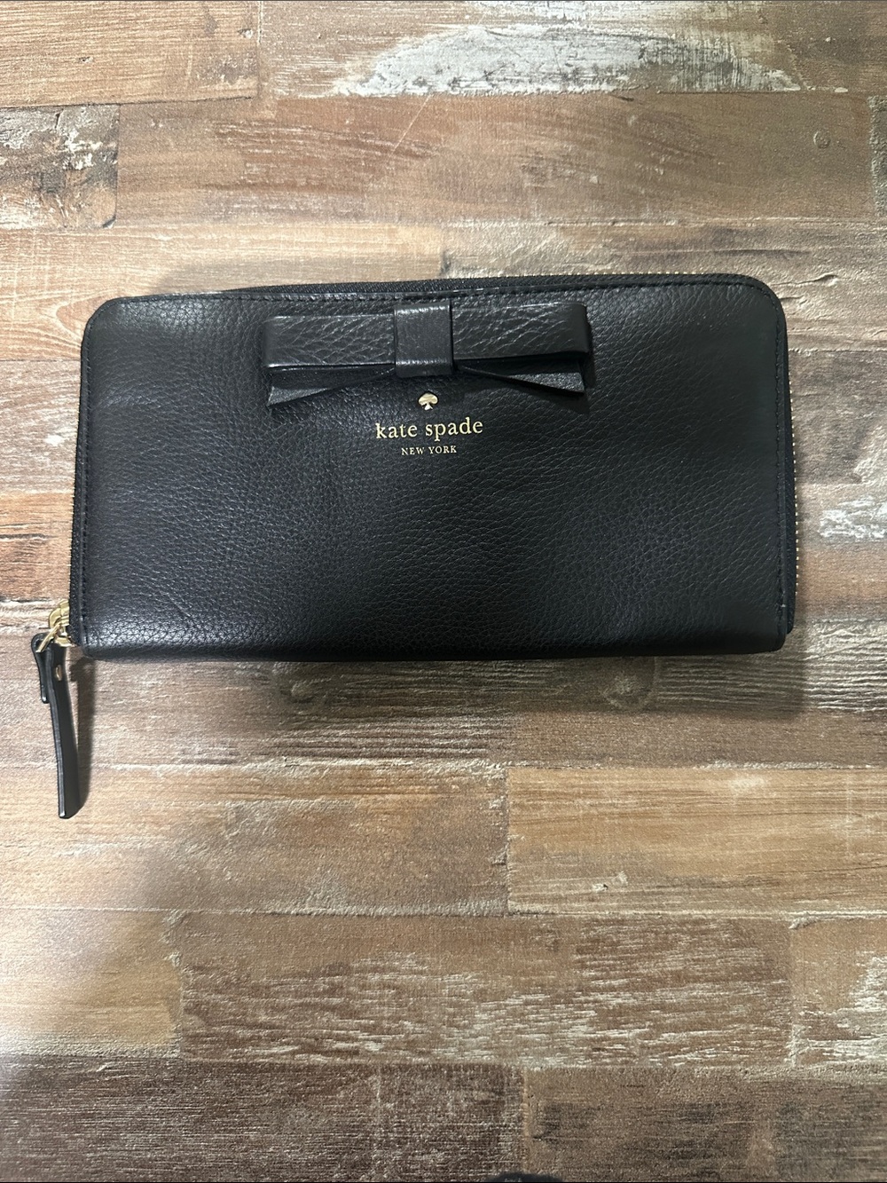 Kate Spade black leather zip-around wallet with bow